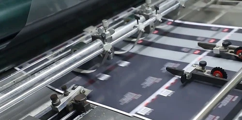 Planchas de embalaje impresas pasando por equipos de producción